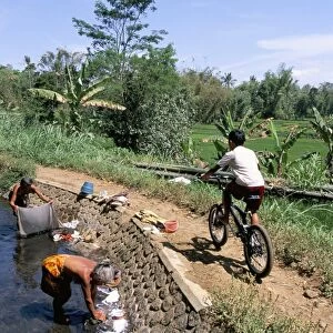 Ladies washing in canal near Candi Suimberawan