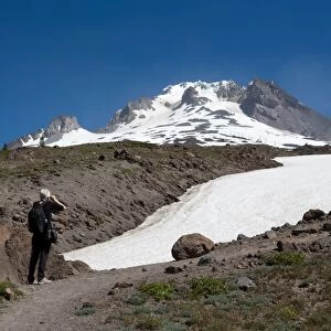 Lady hiker near a glacier on Mount Hood, part of the Cascade Range, Pacific Northwest region