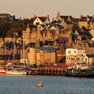 Lerwick, from the sea, waterfront sandstone buildings and golden early morning, Shetland Islands