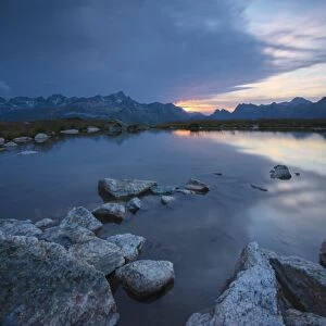 The lights of sunrise reflected in the alpine lake, Muottas Muragl, Samedan, Canton of Graubunden