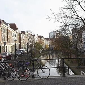 Looking along the Catharijnsingel, bicycles stand on a bridge over a canal in Utrecht