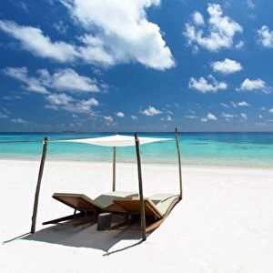 Lounge chairs on tropical white sandy beach, The Maldives, Indian Ocean, Asia