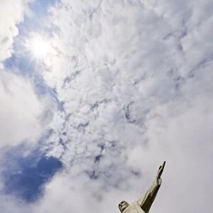Low angle shot of the iconic statue of Christ the Redeemer on a cloudy day with sun