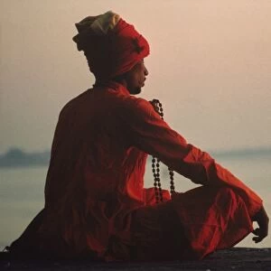 Man with rosary meditating on the banks of the River Ganges, Varanasi, Uttar Pradesh state