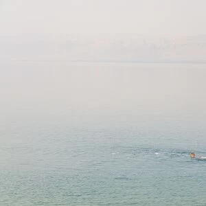 Man swimming in the Dead Sea, Jordan, Middle East