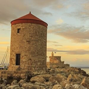 Mandraki Harbour medieval windmill and Fortress at sunset, Rhodes Town, UNESCO World Heritage Site