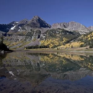 Maroon Bells reflected in Crater Lake with fall color, White River National Forest