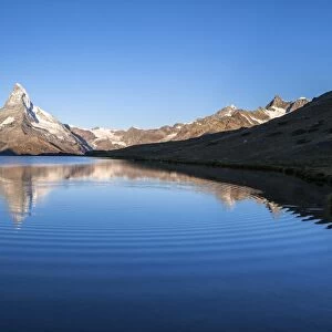 The Matterhorn reflected in Stellisee at sunrise, Zermatt, Canton of Valais, Pennine Alps