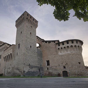 Medieval castle of Vignola with fortified tower, framed by tree branches, Vignola, Emilia Romagna, Italy, Europe