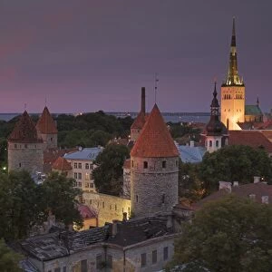 Medieval town walls, defence towers and spire of St. Olavs church at sunset