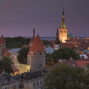 Medieval town walls, defence towers and spire of St. Olavs church at sunset