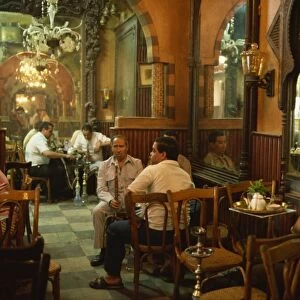 Men smoking hookahs in the interior of the El Fishawy Coffee House in Khan al-Kalili Bazaar in Cairo, Egypt, North