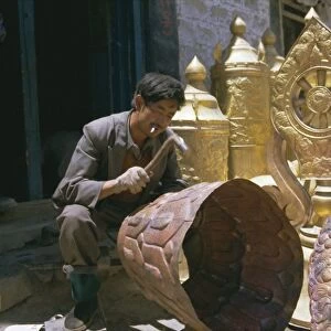Metalsmith making temple ornaments, Lhasa, Tibet, China, Asia