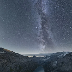 Milky Way in the starry night sky over lake Limmernsee, aerial view, Canton of Glarus