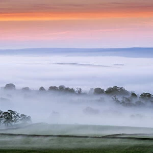 Mist rising over East Halton and Embsay at sunrise, in Lower Wharfedale, North Yorkshire
