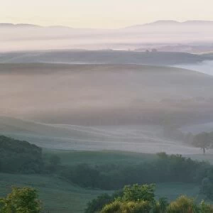Misty dawn view across Val d Orcia towards the Belvedere