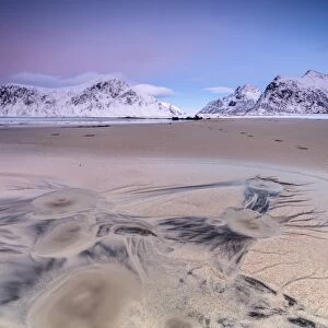 Full moon reflected on sand in the surreal scenery of Skagsanden beach, Flakstad