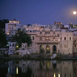 Moonlit view of Gangaur Ghat, with old city gateway, Udaipur, Rajasthan state