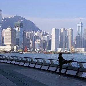Morning exercise, Victoria Harbour and Hong Kong Island skyline, Hong Kong, China, Asia