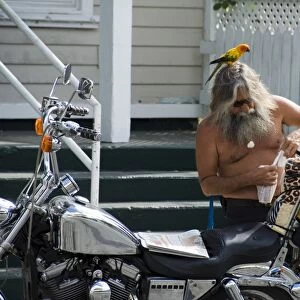 Motorcyclist with bird on head