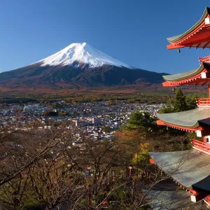 Mount Fuji capped in snow and the upper levels of a temple