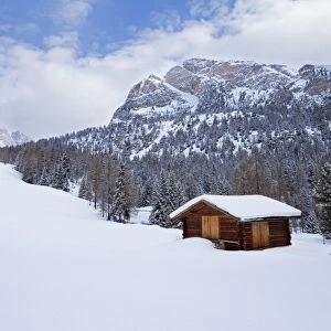 Mountain hut and landscape covered in winter snow, Val Gardena, Dolomites