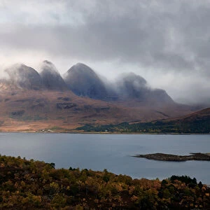 Mountains in the mist facing a lake in the Scottish Highlands, Scotland, United Kingdom