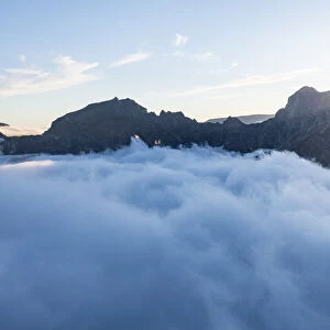 Mountains in a sea of clouds at sunset viewed from Pico Ruivo, Madeira, Portugal