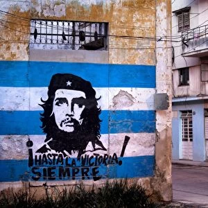 Mural of Che Guevara and the Cuba, West Indies, Central American flag painted on a wall, Havana, Cuba, West Indies, Central America