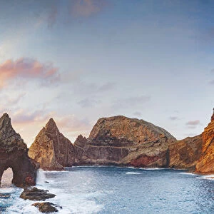 Natural arch, stone rocks and cliffs at dawn from Ponta do Rosto viewpoint