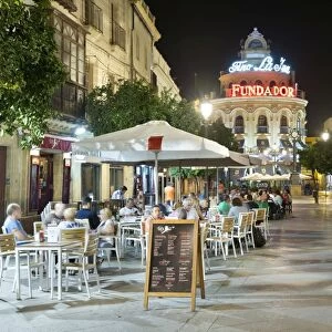 Night view of cafes along Calle Lanceria and El Gallo Azul rotunda building, Jerez de la Frontera