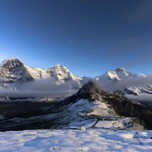 Night view of Eiger, Monch and Jungfrau mountains covered with snow from Mannlichen
