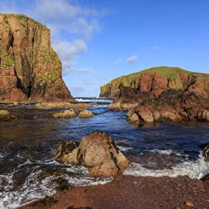 North Ham Bay, deep inlet, lichen covered red granite cliffs and stacks, seaweed
