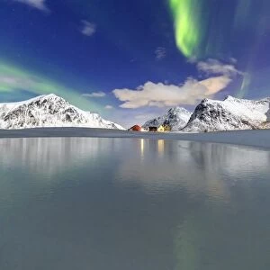 Northern Lights (aurora borealis) reflected in the cold waters, Flakstad, Lofoten Islands