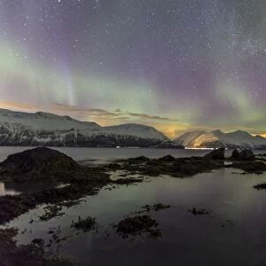 Northern Lights on the icy landscape of Svensby, Lyngen Alps, Troms, Lapland, Norway