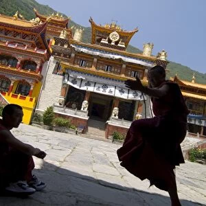 Novice Buddhist monks sparring, Nanwu temple, Kangding, Sichuan, China, Asia