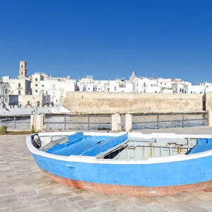 Old boat with the Italian old town in the background, Monopoli, Apulia, Italy, Europe