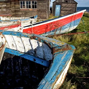 Old fishing boats and delapidated fishermens huts, Beadnell, Northumberland