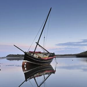 Old ketch reflecting in Aln Estuary as tide rises, Alnmouth, Northumberland