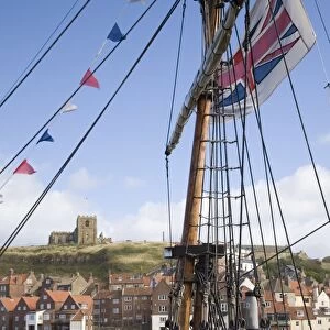 Old Port and St. Marys church on East Cliff across River Esk, through rigging of replica of Captain Cooks ship Bark Endeavour, Whitby, Heritage Coast of North East England, North Yorkshire, England, United