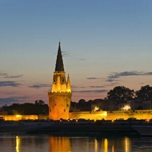 Old prison tower seen across the harbour entrance at dusk, La Rochelle