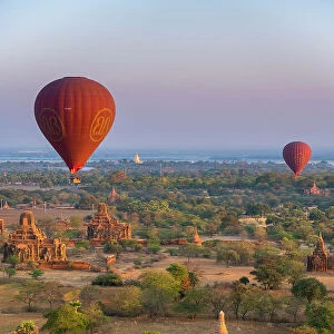 Old temples in Bagan and hot-air balloons before sunrise, Old Bagan (Pagan), UNESCO World Heritage Site, Myanmar (Burma), Asia