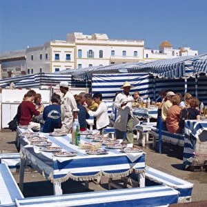 Open air fish restaurants and stalls by the sea to grill fresh fish