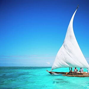 Outrigger canoe with sail on Indian Ocean, off Jambiani, Zanzibar, Tanzania