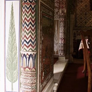 Detail of painted column and cypress tree in dining