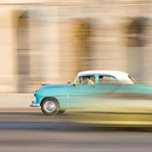 Panned shot of a classic American car on The Malecon, Havana, Cuba, West Indies