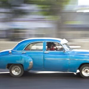 Panned shot of old American car to capture sense of movement, Prado, Havana Centro, Cuba, West Indies, Central America