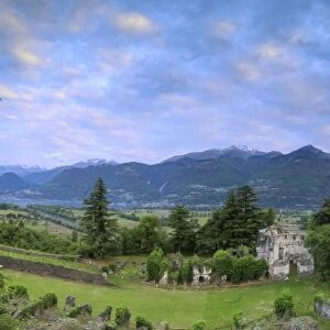 Panorama of ancient ruins of Fort Fuentes framed by green hills at dawn, Colico, Lecco province