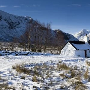 Panoramic view of Black Rock Cottage with Buachaille Etive Mor in distance on snow covered Rannoch Moor, near Fort William, Highland, Scotland, United