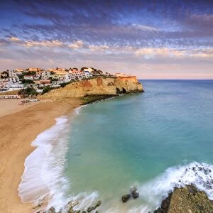 Panoramic view of Carvoeiro village surrounded by sandy beach and clear sea at sunset